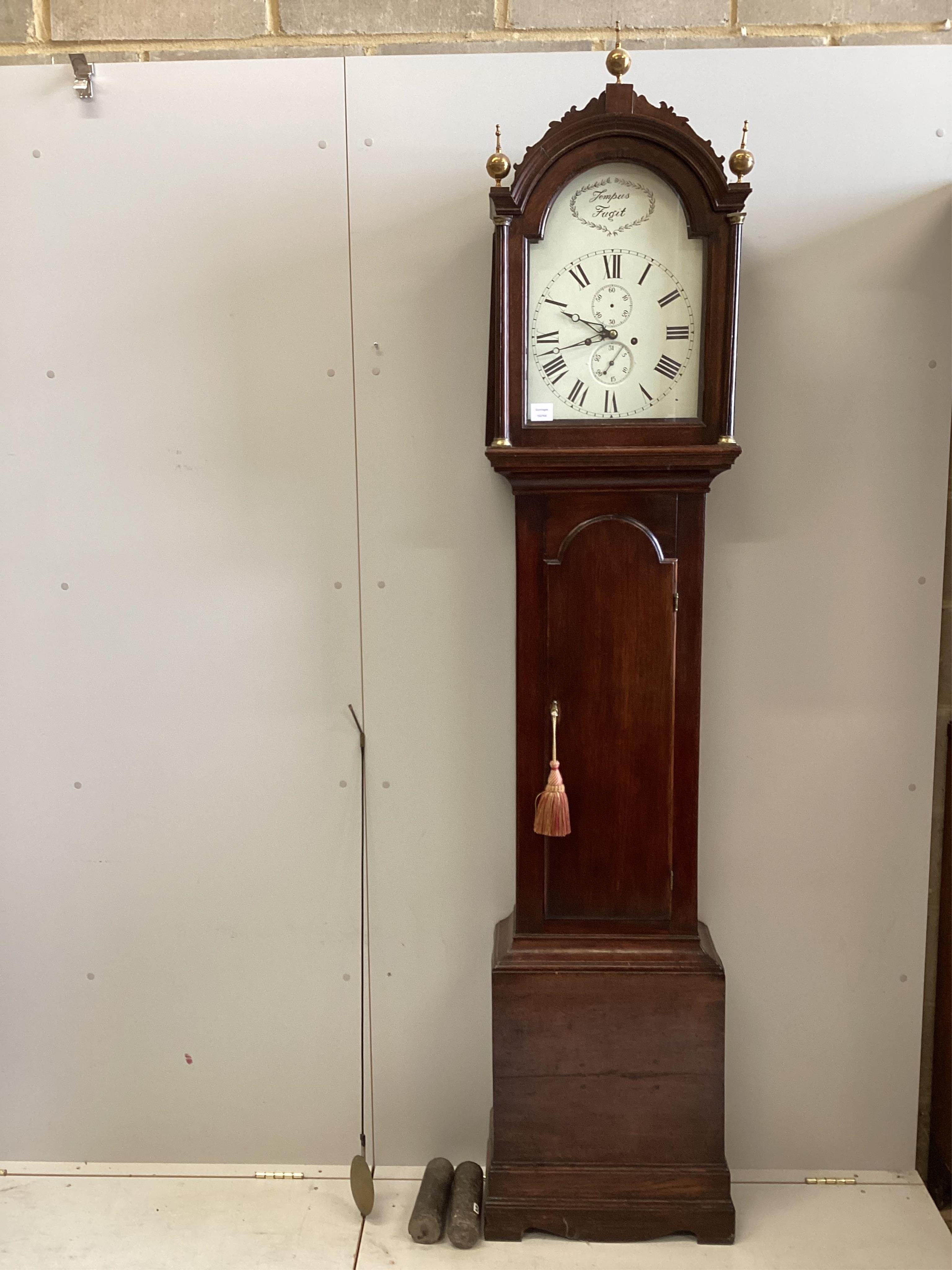 A George III mahogany eight day longcase clock, the arched silvered dial inscribed Tempus Fugit, height 232cm. Condition - good